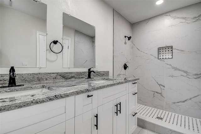 3841 Wahoo Dr SE, Saint Petersburg, FL 33705 - bathroom with marble finish floor, double vanity, a marble finish shower, and a sink