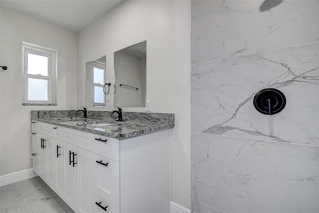 3841 Wahoo Dr SE, Saint Petersburg, FL 33705 - bathroom with double vanity, marble finish floor, a sink, and baseboards