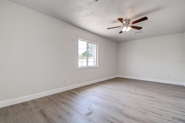 3841 Wahoo Dr SE, Saint Petersburg, FL 33705 - spare room featuring wood finished floors, ceiling fan, baseboards, and visible vents