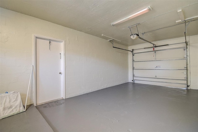 3841 Wahoo Dr SE, Saint Petersburg, FL 33705 - garage featuring concrete block wall and a garage door opener