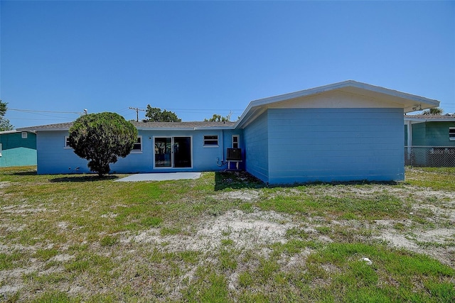 3841 Wahoo Dr SE, Saint Petersburg, FL 33705 - back of property with a patio area, fence, a lawn, and central air condition unit