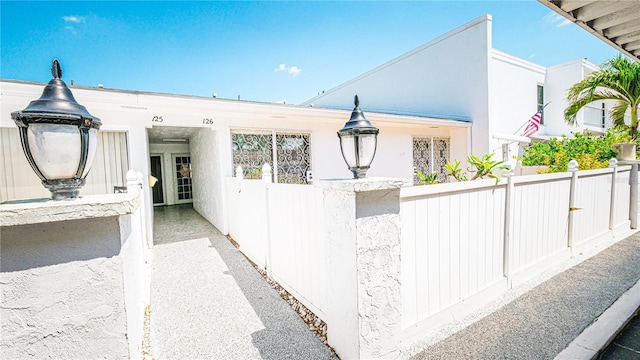 1655 S Highland Ave Unit F126, Clearwater, FL 33756 - view of home's exterior with a fenced front yard and stucco siding