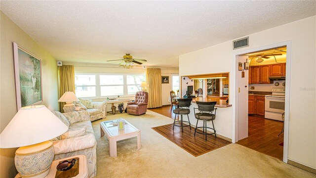 1655 S Highland Ave Unit F126, Clearwater, FL 33756 - living room with dark carpet, ceiling fan, visible vents, and a textured ceiling