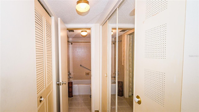 1655 S Highland Ave Unit F126, Clearwater, FL 33756 - hallway with tile patterned floors and a textured ceiling