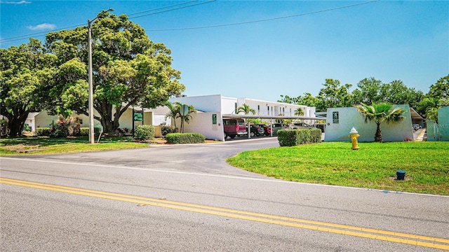 1655 S Highland Ave Unit F126, Clearwater, FL 33756 - view of front of house with stucco siding and a front lawn