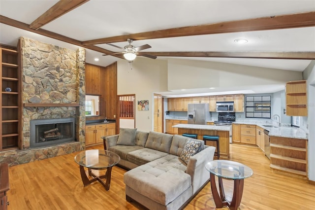 170 Foxfire Ln, Oldsmar, FL 34677 - living area with a ceiling fan, a stone fireplace, beamed ceiling, light wood-style flooring, and recessed lighting