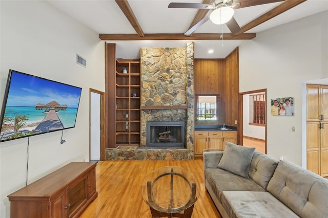 170 Foxfire Ln, Oldsmar, FL 34677 - living area featuring a towering ceiling, visible vents, light wood-style floors, a fireplace, and ceiling fan