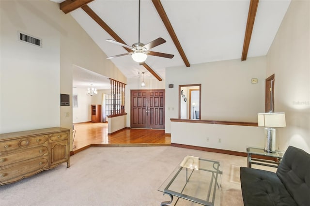170 Foxfire Ln, Oldsmar, FL 34677 - unfurnished living room featuring beam ceiling, visible vents, light colored carpet, ceiling fan with notable chandelier, and high vaulted ceiling