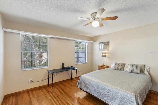 170 Foxfire Ln, Oldsmar, FL 34677 - bedroom with ceiling fan, baseboards, wood finished floors, and a textured ceiling