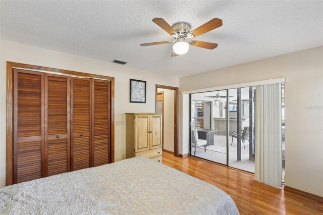 170 Foxfire Ln, Oldsmar, FL 34677 - bedroom featuring a textured ceiling, light wood-type flooring, visible vents, and access to outside