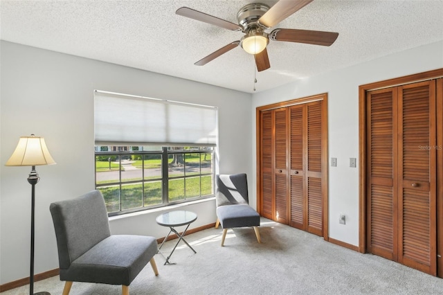 170 Foxfire Ln, Oldsmar, FL 34677 - sitting room with baseboards, a ceiling fan, carpet flooring, and a textured ceiling