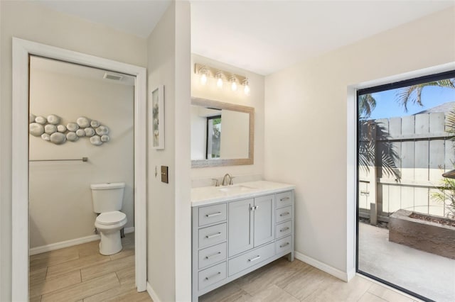 170 Foxfire Ln, Oldsmar, FL 34677 - bathroom with wood finished floors, visible vents, toilet, vanity, and baseboards