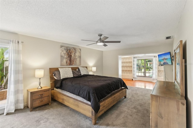 170 Foxfire Ln, Oldsmar, FL 34677 - bedroom featuring a textured ceiling, visible vents, light colored carpet, and ceiling fan