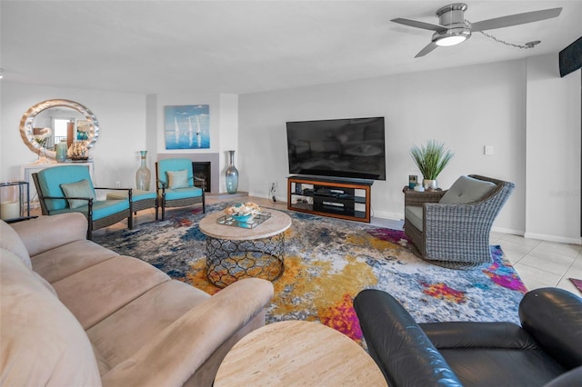 tiled living room with baseboards and a ceiling fan