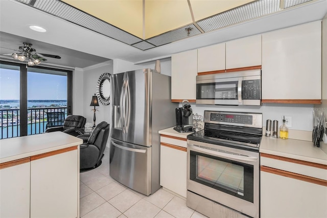 kitchen featuring ceiling fan, light tile patterned floors, white cabinetry, light countertops, and stainless steel appliances