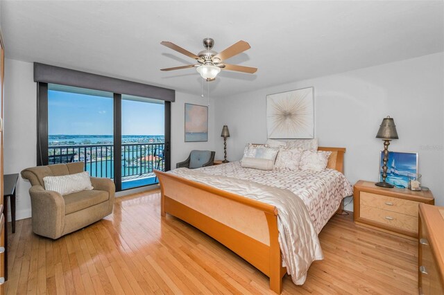 bedroom with access to outside, light wood-type flooring, and a ceiling fan