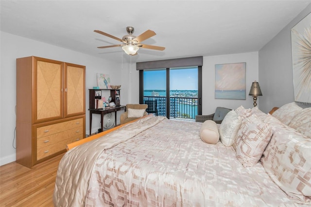bedroom featuring baseboards, access to outside, light wood-style floors, and a ceiling fan