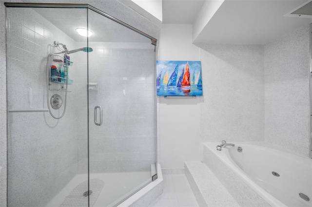 full bathroom featuring tile patterned floors, a bath, and a stall shower