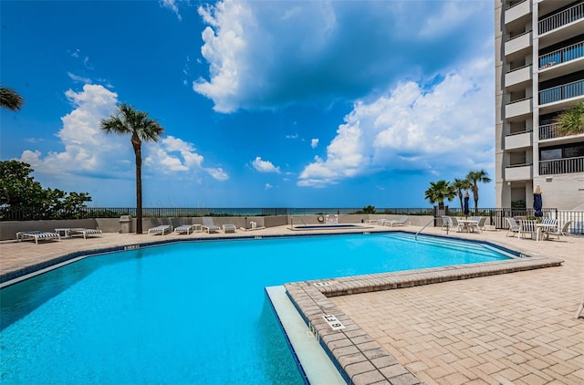 community pool featuring a patio area and fence