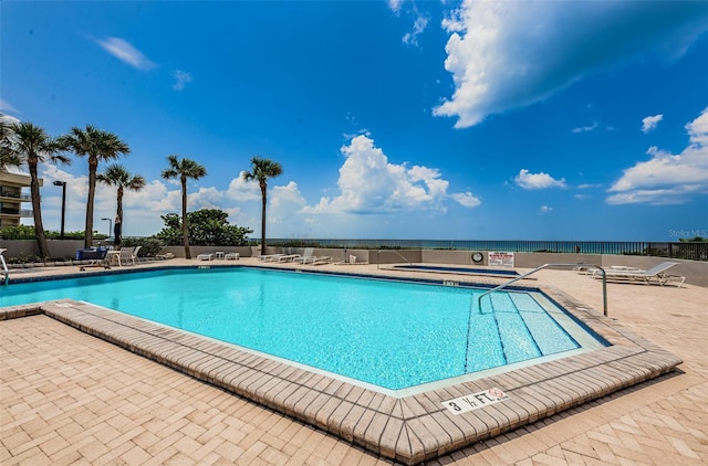 community pool featuring a patio and fence