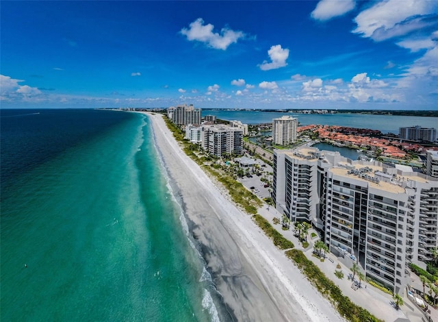 drone / aerial view with a water view and a beach view