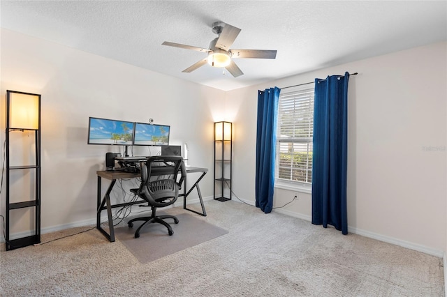 office area with ceiling fan, carpet floors, a textured ceiling, and baseboards