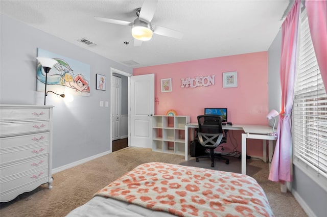 carpeted bedroom with ceiling fan and baseboards