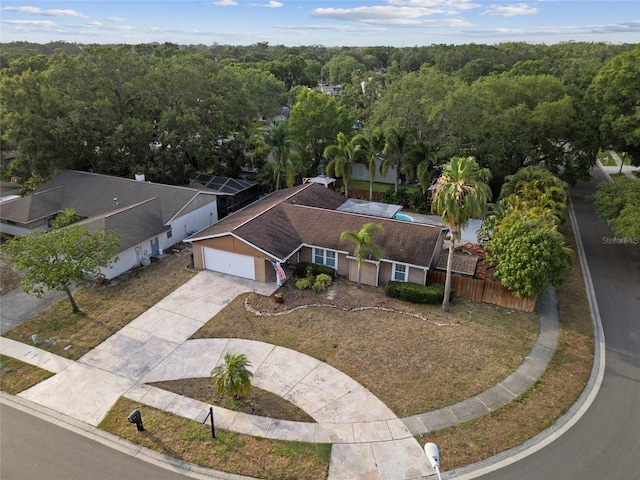 aerial view of property and surrounding area with a heavily wooded area
