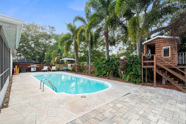 view of pool featuring a hot tub, a patio area, and a fenced backyard