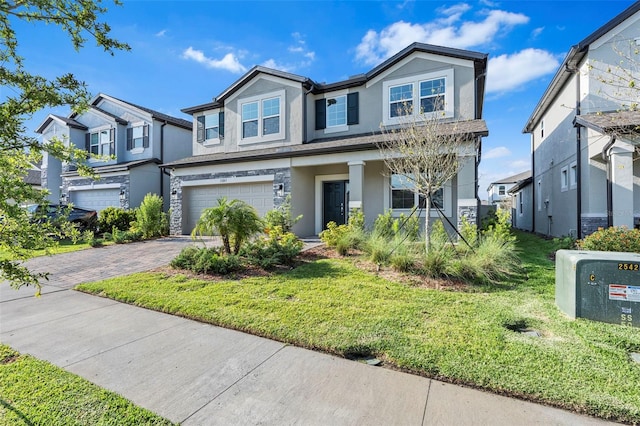 view of front facade with a residential view, stucco siding, driveway, a front lawn, and a garage