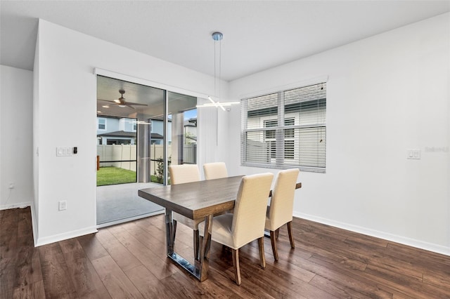 dining room featuring ceiling fan, baseboards, and dark wood-style floors