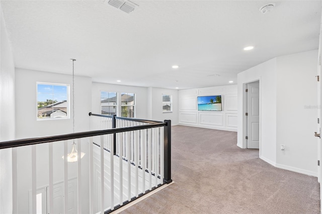 corridor featuring carpet, visible vents, recessed lighting, an upstairs landing, and baseboards
