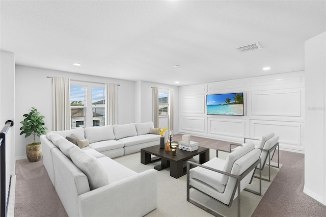 living area featuring carpet flooring, visible vents, and recessed lighting
