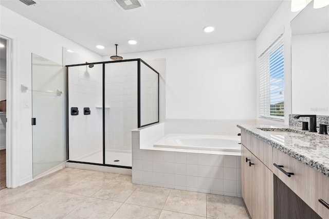full bath featuring vanity, a shower stall, tile patterned flooring, and a garden tub
