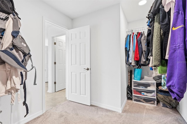 walk in closet with carpet