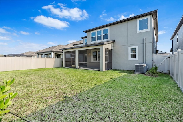 back of house with stucco siding, cooling unit, a fenced backyard, a yard, and a sunroom