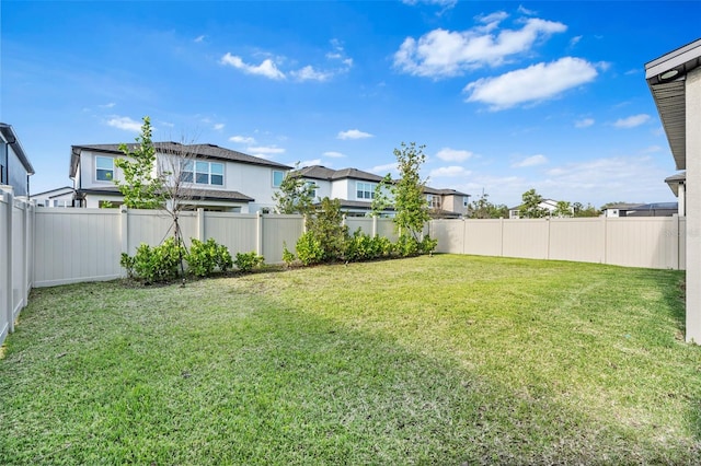 view of yard with a residential view and a fenced backyard