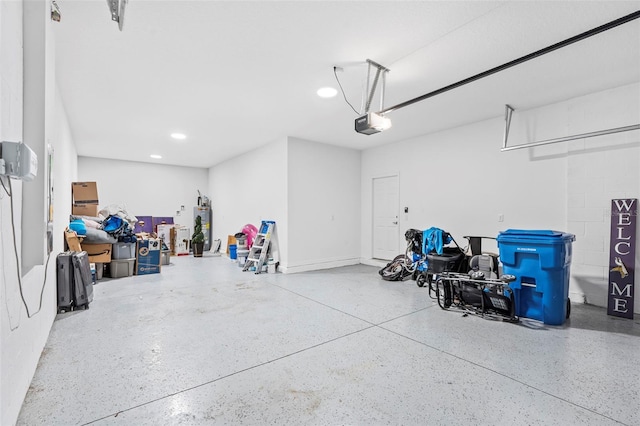 garage with water heater, recessed lighting, and a garage door opener
