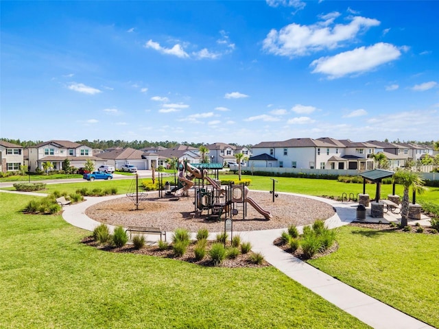 communal playground with a residential view and a yard