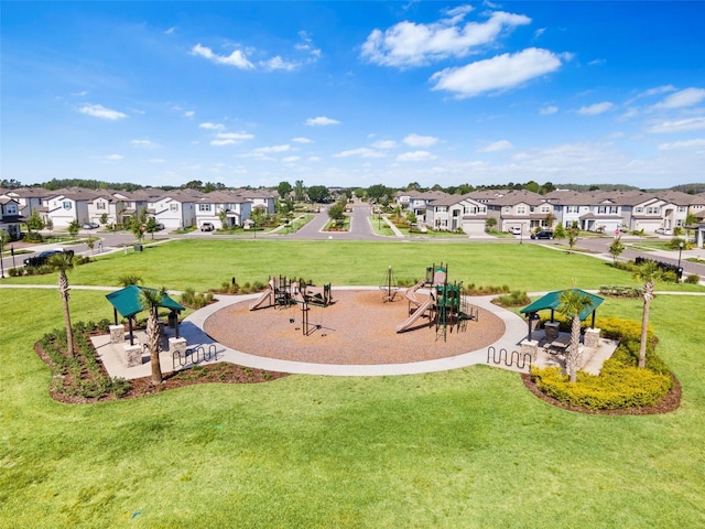view of home's community with a yard, a residential view, and playground community