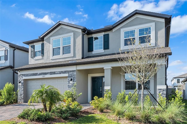 33263 Sycamore Leaf Dr, Wesley Chapel, FL 33545 - view of front facade with stucco siding, an attached garage, and decorative driveway