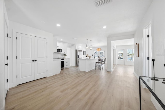 9920 Spoonbill Rd E, Bradenton, FL 34209 - living room with light wood-style flooring, recessed lighting, and baseboards