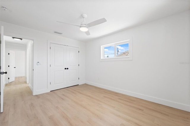 9920 Spoonbill Rd E, Bradenton, FL 34209 - unfurnished bedroom featuring light wood finished floors, baseboards, a closet, and ceiling fan