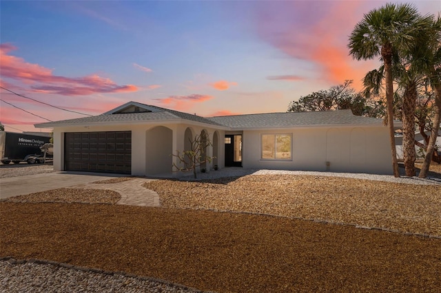 9920 Spoonbill Rd E, Bradenton, FL 34209 - ranch-style house featuring an attached garage, stucco siding, and driveway