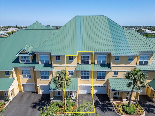 6451 Sunset Bay Cir, Apollo Beach, FL 33572 - view of building exterior with an attached garage and driveway