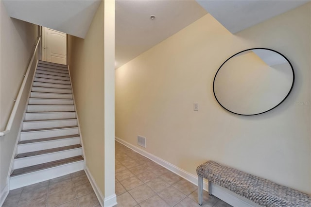 6451 Sunset Bay Cir, Apollo Beach, FL 33572 - stairway with tile patterned flooring, visible vents, and baseboards