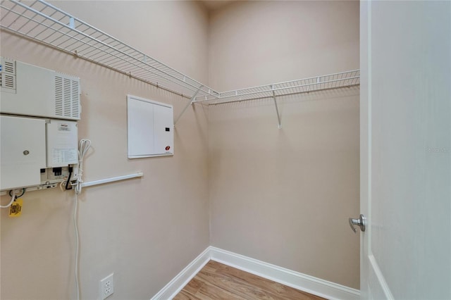 6451 Sunset Bay Cir, Apollo Beach, FL 33572 - laundry area with light wood-style flooring and baseboards