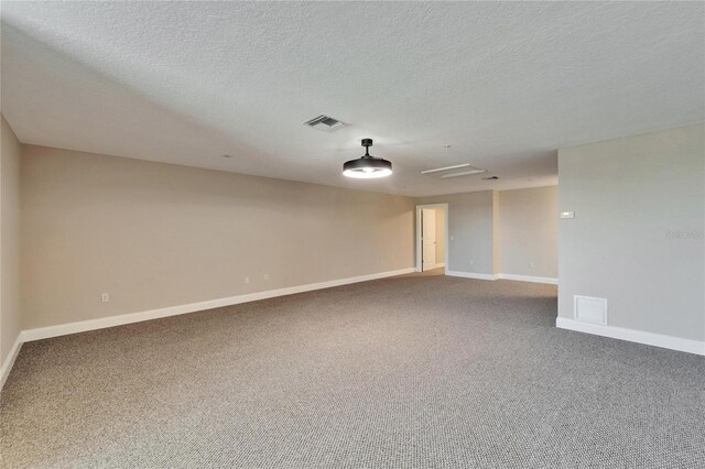6451 Sunset Bay Cir, Apollo Beach, FL 33572 - carpeted spare room featuring a textured ceiling, baseboards, and visible vents