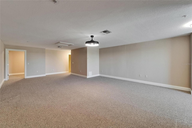 6451 Sunset Bay Cir, Apollo Beach, FL 33572 - unfurnished room with a textured ceiling, visible vents, attic access, carpet flooring, and baseboards