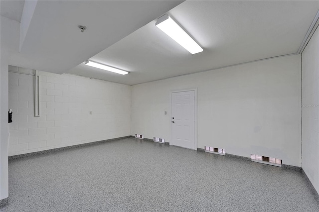 6451 Sunset Bay Cir, Apollo Beach, FL 33572 - empty room with speckled floor, baseboards, visible vents, and concrete block wall